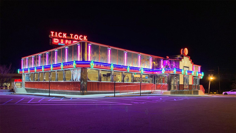 Outside of Tick Tock Diner at night, lit with Solid Apollo LED neon lights.